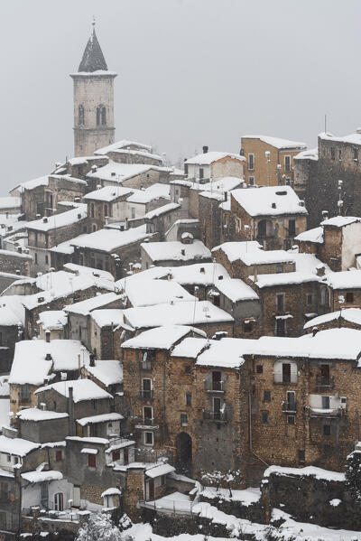 The medieval village of Pacentro under heavy snowfall  with snow covered house and tower bell, Pacentro municipality, Maiella national park, L’aquila province, Abruzzo, Italy