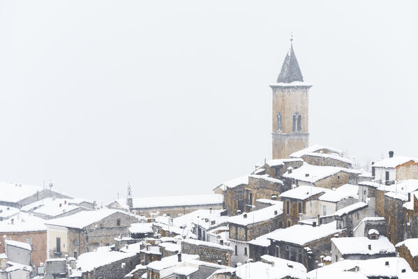 The medieval village of Pacentro under heavy snowfall  with snow covered house and tower bell, Pacentro municipality, Maiella national park, L’aquila province, Abruzzo, Italy