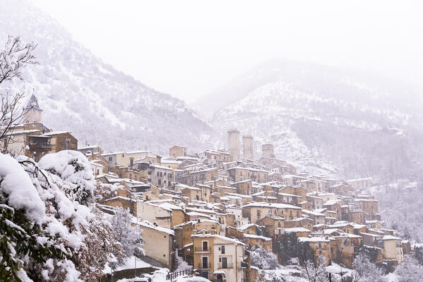 The panoramic medieval village of Pacentro under heavy snowfall  with the castle, the tower bell and snow covered house, Pacentro municipality, Maiella national park, L’aquila province, Abruzzo, Italy