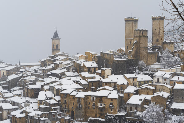 The medieval village of Pacentro under heavy snowfall  with the castle, the tower bell and snow covered house, Pacentro municipality, Maiella national park, L’aquila province, Abruzzo, Italy