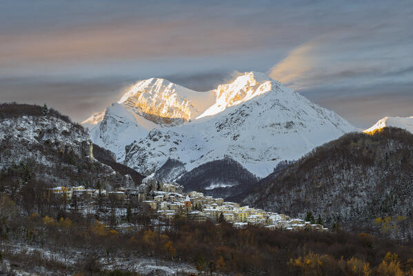 Autums sunrise in the snowy mountain village of Pietracamela with the majestic Intermesoli peak in the background, Gran Sasso and Monti della Laga national park, Teramo province, Abruzzo, Italy