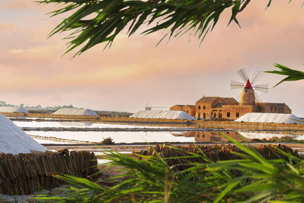 Sunset at the salt flats with the old windmill, saline dello Stagnone, Marsala, Trapani province, Sicily, Italy