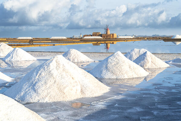 Salt pyramids at the salt flats with old windmill, saline dello Stagnone, Marsala, Trapani province, Sicily, Italy