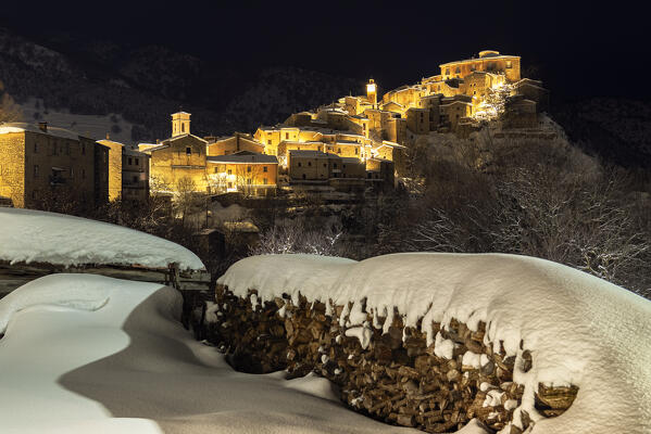 Night view on the illuminated snow covered village of Villalago, Abruzzo national park, L’aquila province, Abruzzo, Italy