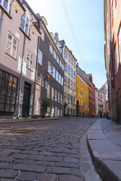 View from below of the colourful buildings in the cobbled medieval Magstraede street, Copenhagen, Hovedstaden Denmark, Europe
