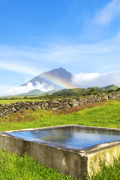 Mount pico and its reflection in the water with rainbow, Lajes do Pico municipality, Pico island (Ilha do Pico), Azores archipelago, Portugal, Europe