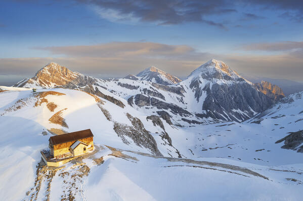 Aerial view of the Duca degli Abruzzi hut during spring thaw at sunrise, Campo Imperatore, Gran Sasso and Laga Mountains National Park, L'Aquila province, Abruzzo, Italy, Europe