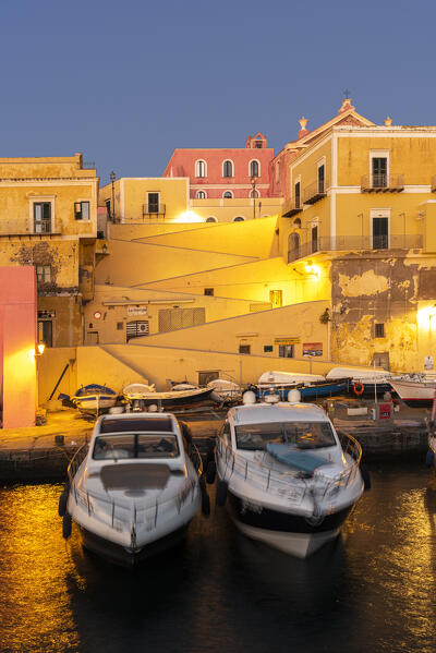 View of boats anchored in the water of the roman harbour of Ventotene village iluminated at dawn, Ventotene island, Pontine islands, Tyrrhenian sea, Mediterranean sea, Latium, central Italy, Italy, Southern Europe, Europe.