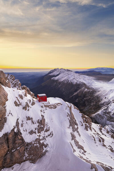 Panoramic aerial winter view of Bafile hut (bivacco Bafile), Campo Imperatore plateau and Gran Sasso mountain range with snow at sunrise, Campo Imperatore, Gran Sasso e Monti della Laga National Park, L'Aquila province, Abruzzo region, central Italy, Italy, Europe