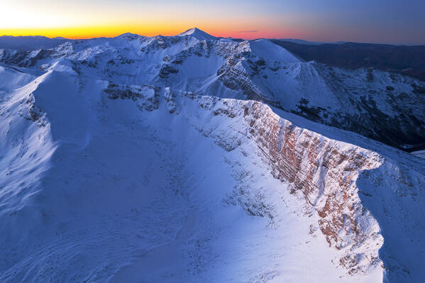 Aerial winter view of the massif of Costone covered with snow at sunrise, Sirente Velino regional and natural park, L'Aquila province, Abruzzo region, central Italy, Italy, Europe