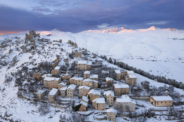The small village covered with snow of Rocca Calascio and the fortress on top, winter aerial view, Rocca Calascio, Gran Sasso e Monti della Laga national park, Apennines, L'Aquila province, Abruzzo region, central Italy, Italy, Europe