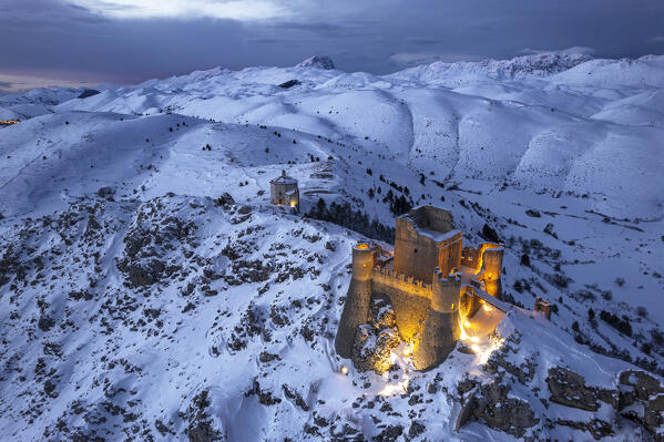 Illuminated high angle view of the castle of Rocca Calascio and the church  Santa Maria della Pietà at dusk, Gran Sasso e Monti della Laga National Park, Apennines, L'Aquila province, Abruzzo region, central Italy, Italy, Europe