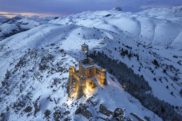 Illuminated high angle view of the castle of Rocca Calascio and the church Santa Maria della Pietà at dusk, Gran Sasso e Monti della Laga National Park, Apennines, L'Aquila province, Abruzzo region, central Italy, Italy, Europe