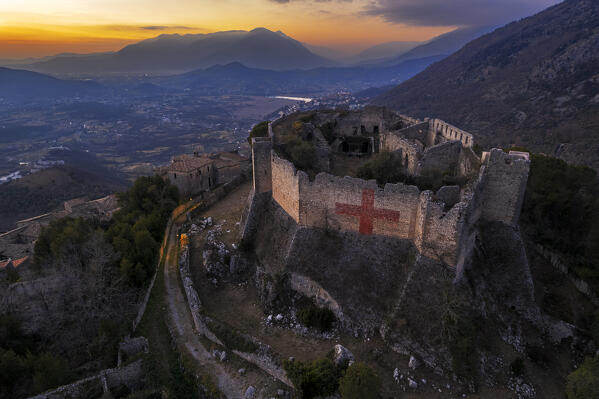 Aerial view of the medieval castle of Vicalvi overlooking the valley with red cross painted on the perimetral wall, at sunset, Vicalvi, Frosinone province, Ciociaria, Latium region, Italy, Europe