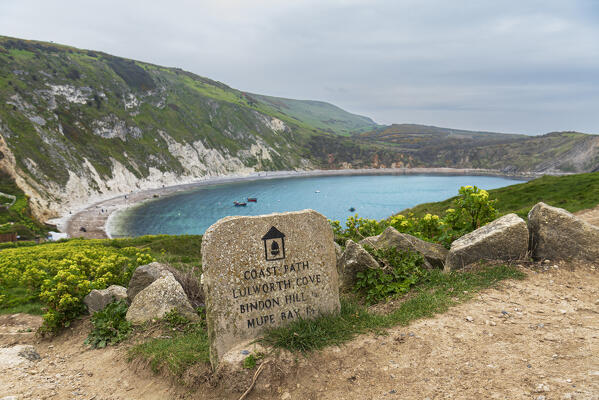 View of Lulworth Cove and the distance marker of the coastal path, Jurassic Coast, UNESCO World Heritage Site, Dorset, England, United Kingdom