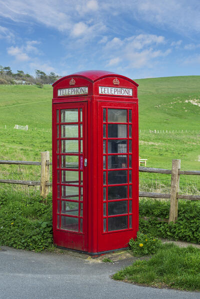 Red British style telephone box in a country setting, Sussex, England, United Kingdom, Europe
