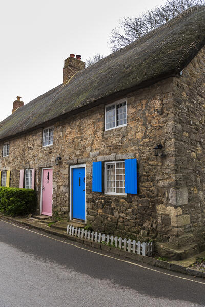 Traditional thatched-roof house with colouful windows in the village of West Lulworth, Jurassic Coast, UNESCO World Heritage Site, Dorset, England, United Kingdom
