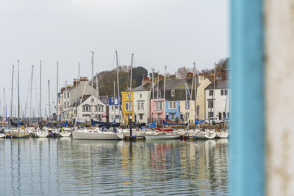 View of the colourful houses and fishing boats in the village of Weymouth, Jurassic Coast, Dorset, England, United Kingdom, Europe