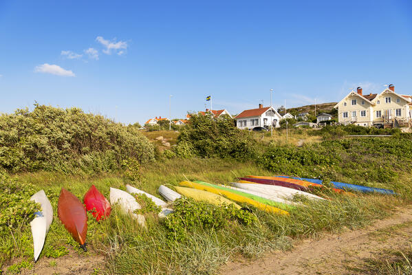 Colorful canoe by the shore on green meadow, Bohuslan, Sweden, Scandinavia, Europe