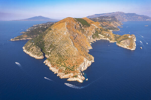 Aerial shot of the promontory of Punta Campanella with Vesuvio volcano in the vbackground, Punta Campanella, Ieranto bay, Massa Lubrense municipality, Amalfi coast, Naples province, Campania region, Italy