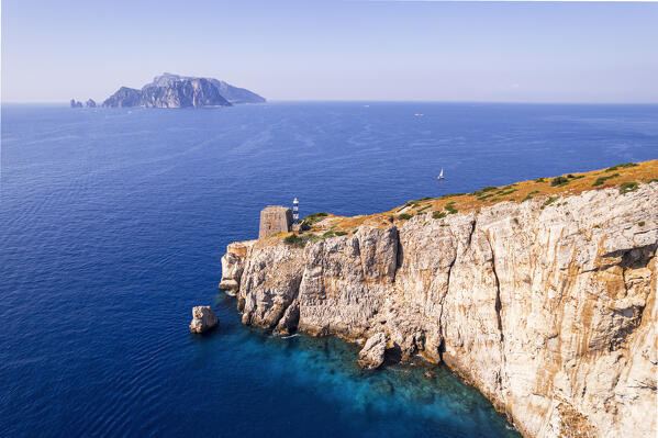 Aerial view of Punta Campanella with the old fortess on top of a cliff and Capri Island in the background, Punta Campanella, Ieranto bay, Massa Lubrense municipality, Amalfi coast, Naples province, Campania region, Italy