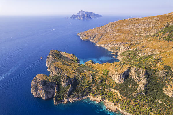 Aerial view of Punta Campanella and Amalfi coast with Capri island in the background, Punta Campanella, Ieranto bay, Nerano, Massa Lubrense municipality, Amalfi coast, Naples province, Campania region, Italy