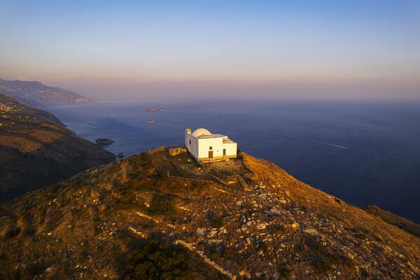 Iconic white church of San Costanzo on top of the mountain surrounding Amalfi coast, Punta Campanella, Ieranto bay, Nerano, Massa Lubrense municipality, Amalfi coast, Naples province, Campania region, Tyrrhenian sea, Italy