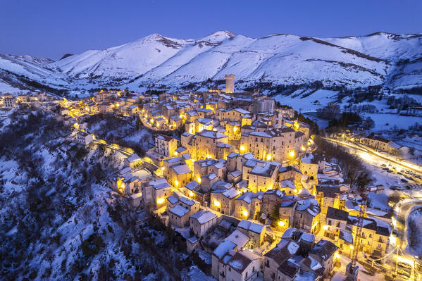Illuminated mountain village of Santo Stefano di Sessanio covered with snow, Gran Sasso and Laga Mountains National Park, L'Aquila province, Abruzzo, Apennines, Italy