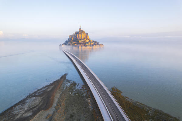 Aerial picture of Mont Saint-Michel during the high tide at sunrise, UNESCO World Heritage Site, Normandy, Manche, France