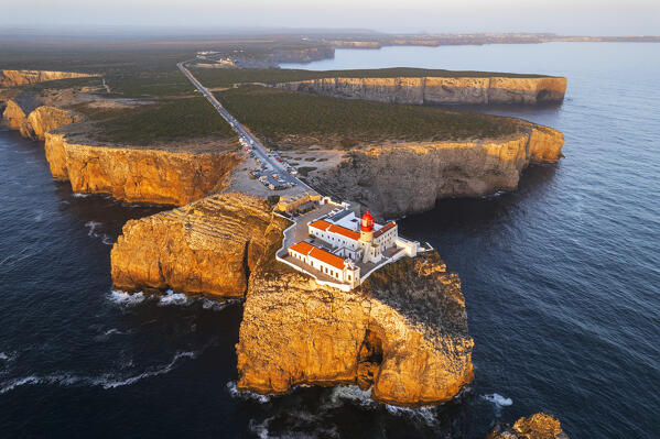 Scenic aerial view of the lighthouse and cliffs at Cape Saint Vincent (Cabo de Sao Vicente) at sunset, Europe's most South-western point, Vila do Bispo municipality, Sagres, Faro district, Algarve, Atlantic Ocean, Portugal, Europe