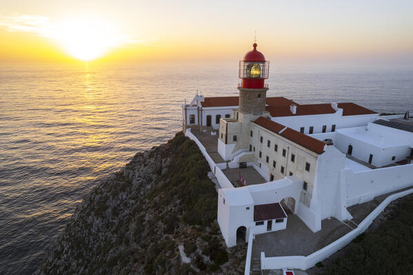 Scenic aerial view of the lighthouse and cliffs at Cape Saint Vincent (Cabo de Sao Vicente) at sunset, Europe's most South-western point, Vila do Bispo municipality, Sagres, Faro district, Algarve, Atlantic Ocean, Portugal, Europe