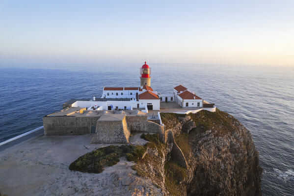 Scenic aerial view of the lighthouse and cliffs at Cape Saint Vincent (Cabo de Sao Vicente) at sunset, Europe's most South-western point, Vila do Bispo municipality, Sagres, Faro district, Algarve, Atlantic Ocean, Portugal, Europe