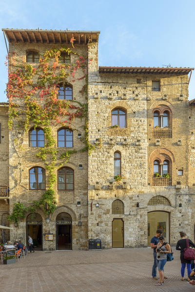 Tourists in the square of San Gimignano. Italy, Tuscany, Siena district.