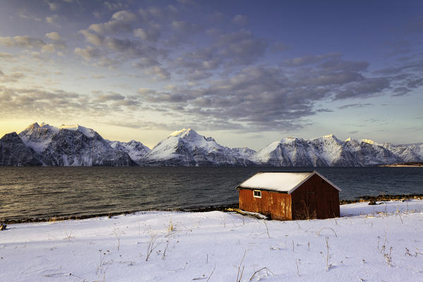 Isolated house in the snow at dawn, Troms county, Europe, Norway.

