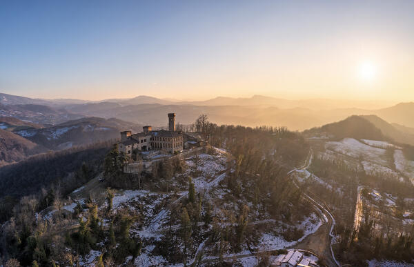 Winter aerial view of the castle San Lorenzo in the Alessandria hills at sunset. Pozzol Groppo, Alessandria province, Piedmont, Italy, Europe. 
