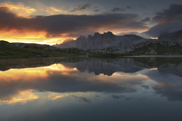Dolomites, Italy. Clouds and colors at dawn reflected in Laghi dei Piani, Sesto Dolomites. Trentino Alto-Adige