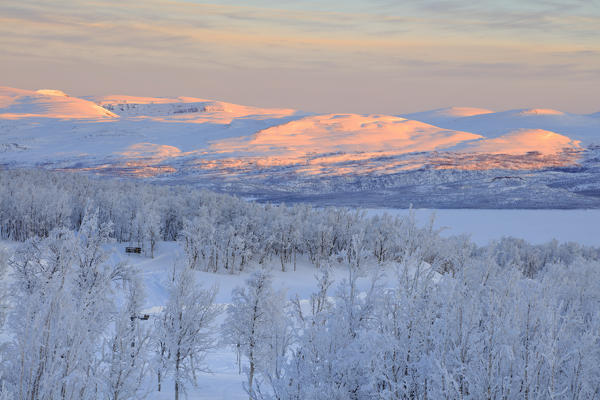 Panoramic of sunrise on the snowy landscape, Bjorkliden, Abisko, Kiruna Municipality, Norrbotten County, Lapland, Sweden