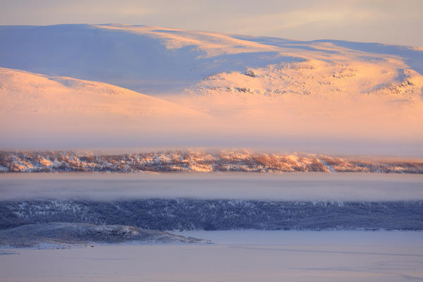 Panoramic of sunrise on the snowy landscape, Bjorkliden, Abisko, Kiruna Municipality, Norrbotten County, Lapland, Sweden