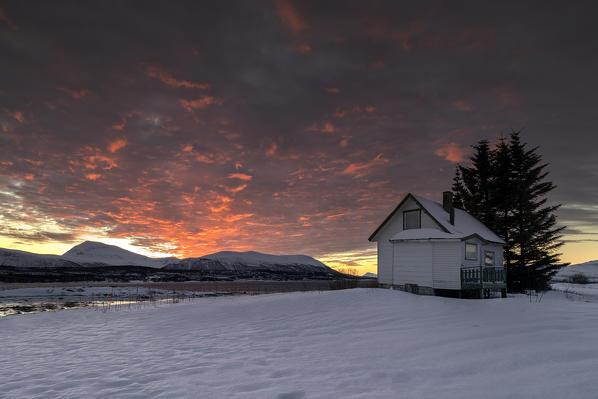 Isolated house in the snow at dawn, Troms, Europe, Norway.
