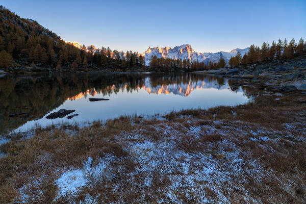 Gran Jorasses reflects in autumn in Arpy lake, Aosta valley,italy, europe