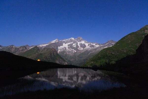 Night at Monte Rosa reflecting in the Alpe Campo Lake, valle d'Aosta, Italy