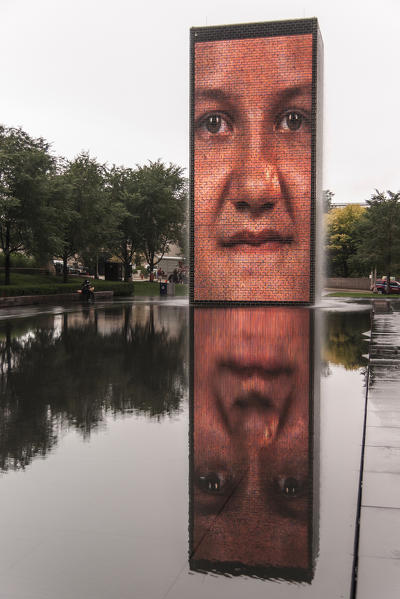 The Crown Fountain in Millennium Park, projecting the faces behind a body of water that runs down its wall; it's a video sculpture. Chicago, Illinois, USA