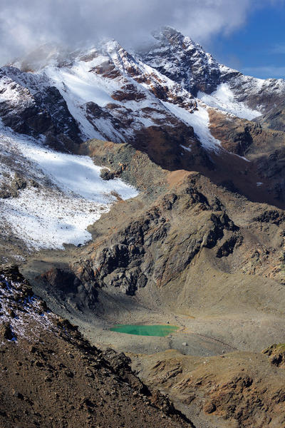 Small glacier lake near Passo di Zebrù, near Rifugio Pizzini hut, Val Cedec, Valfurva, Valtellina, Province of Sondrio, Lombardy, Italy