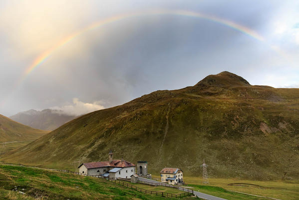 Rainbow above the church of Saint Ranieri, valle del Braulio, near Passo dello Stelvio - Stilfser Joch alpine pass, Valtellina, Province of Sondrio, Lombardy, Italy, Europe