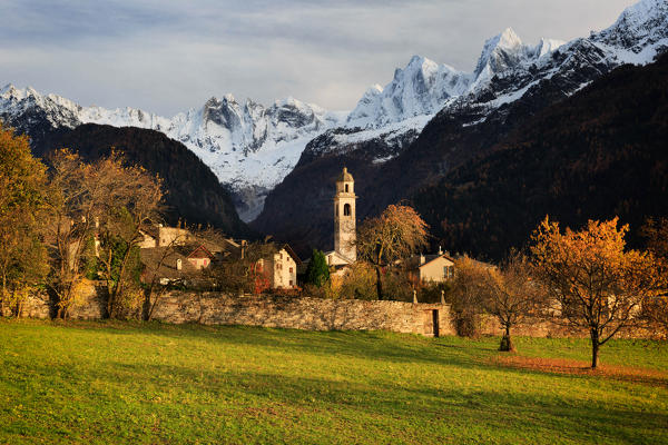 Sunset light on the village of Soglio in autumn, with Sciore peaks, Cengalo and Badile mountains in background, val Bregaglia - Bergell, Canton Grisons, Switzerland, Europe