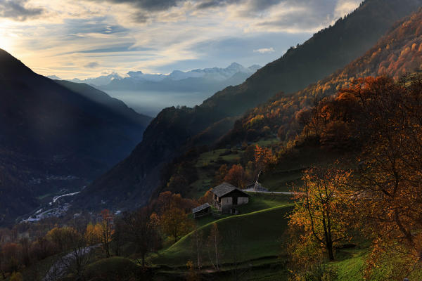 Sunset light from the village of Soglio in autumn towards Italy, val Bregaglia - Bergell, Canton Grisons, Switzerland, Europe