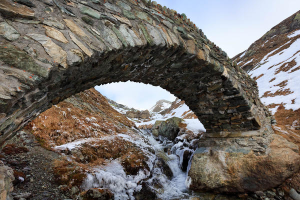 Roman stone bridge near Septimerpass - Pass da Sett in Val Maroz in winter,  Val Bregaglia, Canton Grisons, Switzerland, Europe