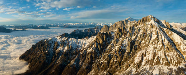 View on Grigna mountain group over the clouds at sunset in winter, grigna meridionale, province of lecco, lombardy, italy, europe