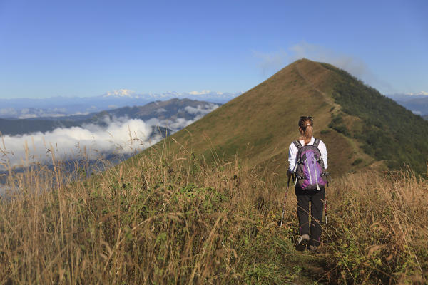 Hiker on the path leading to the summit of Mount San Primo, Triangolo Lariano, Bellagio, Province of Como, Lombardy, Italy