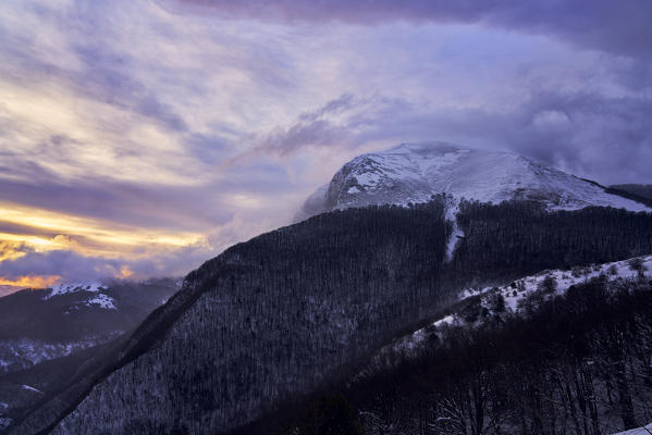 Italy, Umbria, Monte Cucco, Stormy sunrise in Winter